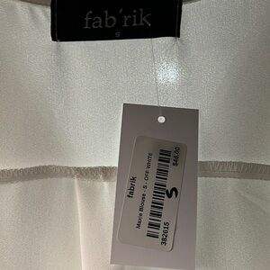 Super cozy, hundred percent polyester, off-white top